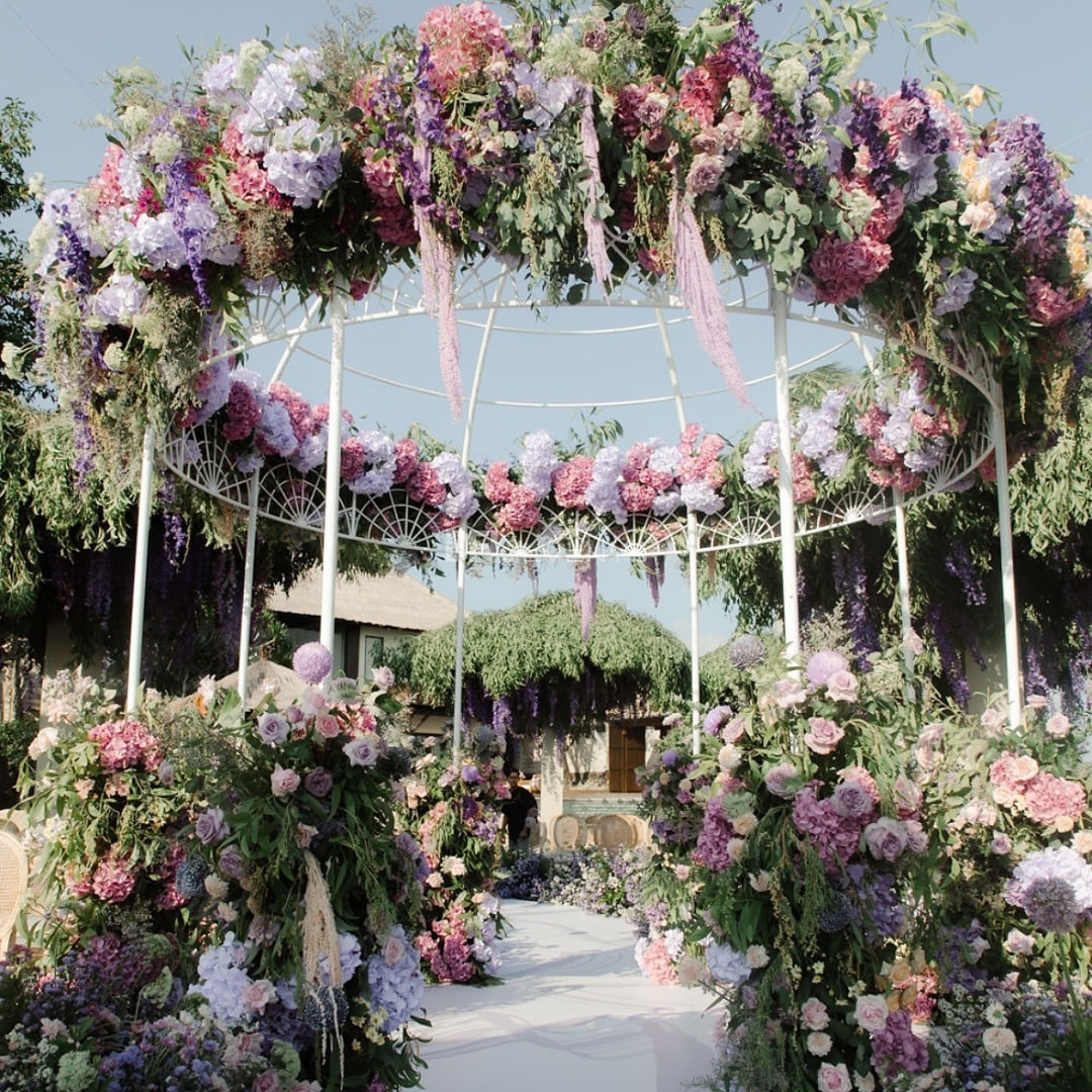 Floral chandelier arch at a Bali wedding ceremony